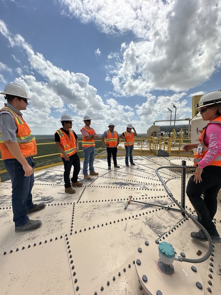 CIG team gathered on top of a storage tank